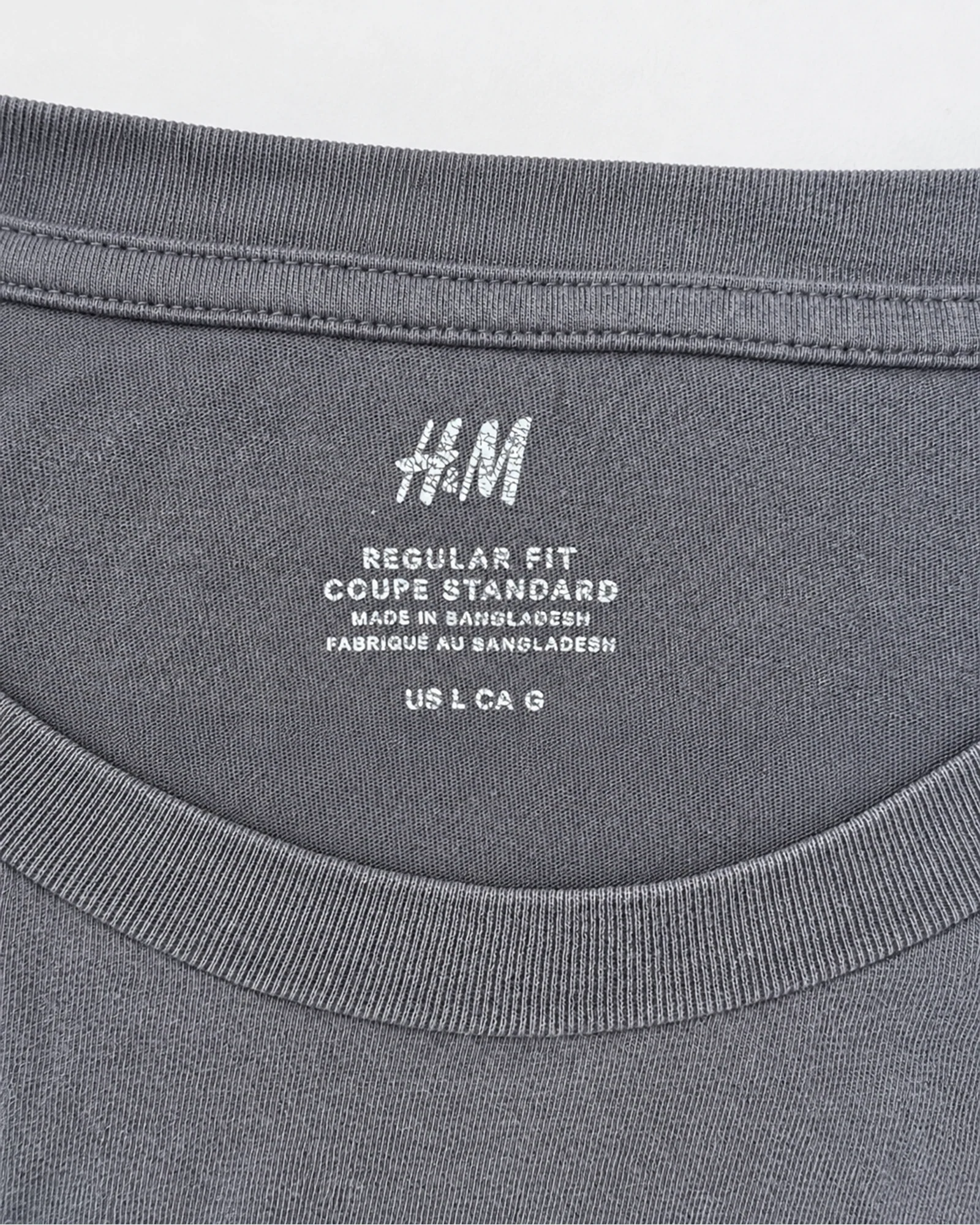 Etiqueta original de marca y talla de camisa o top h&m gris talla us l / ca g