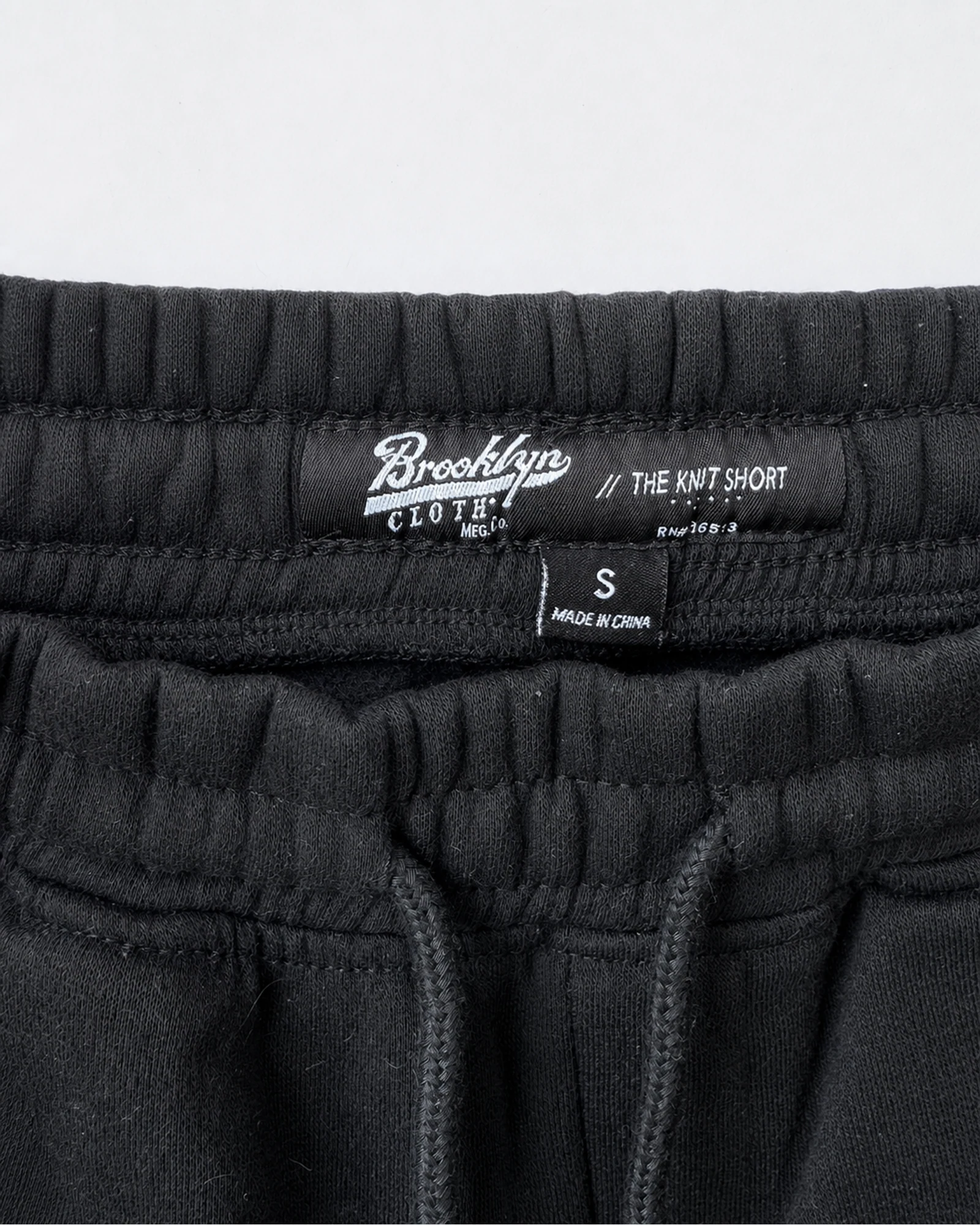 Etiqueta original de marca y talla de short brooklyn cloth negro y charcoal talla s
